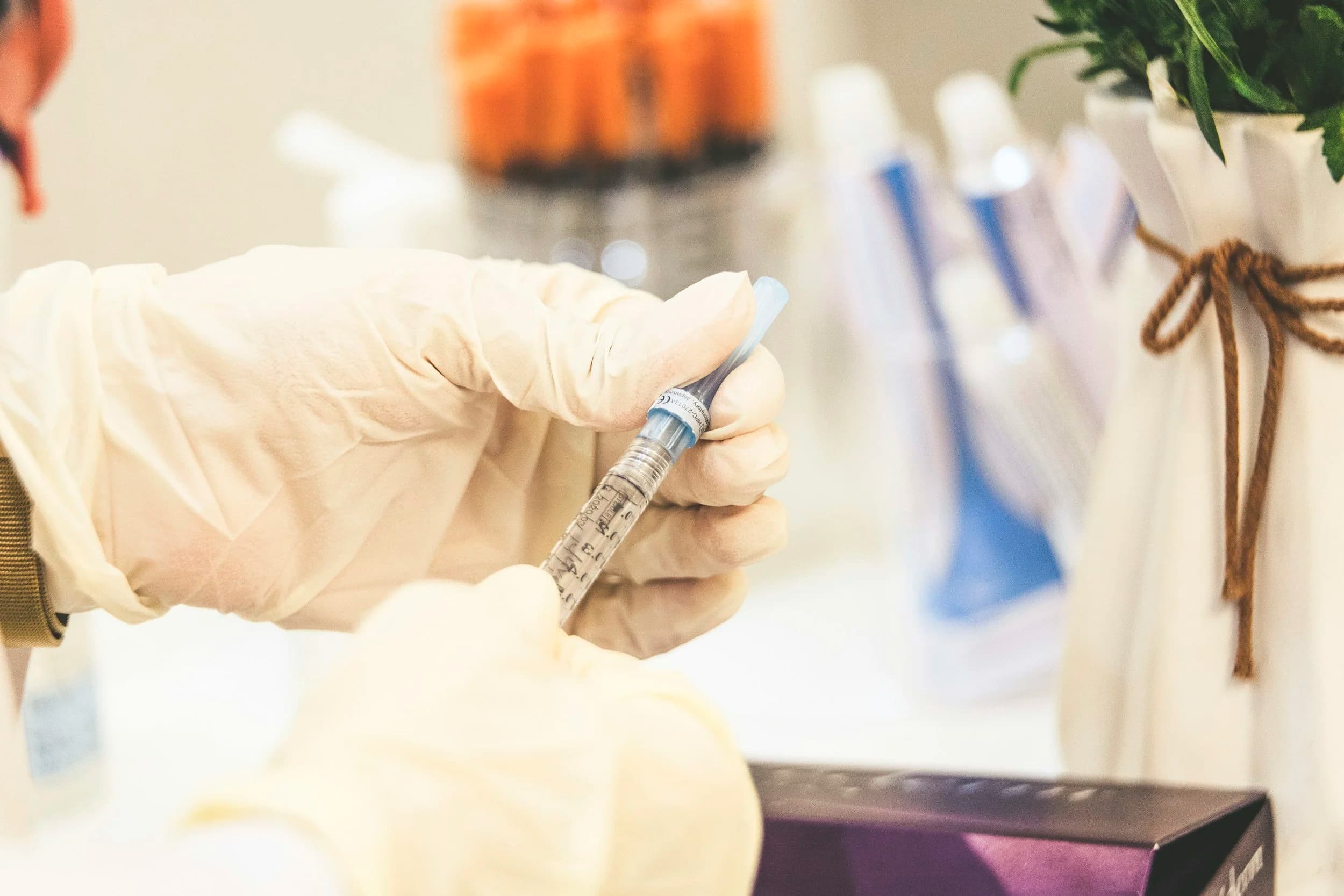 Gloved provider preparing an injectable treatment at La Miel Aesthetics in Raleigh, NC.